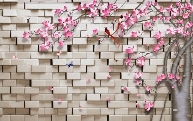 شکوفه های صورتی درخت با دیوار آجری برجسته